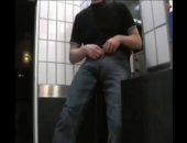 Horny hottie walks around town with a huge bulge in his pants and impressed people in the public toilets.