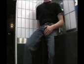 A sexy horny gay black man sits on the sink counter in a public bathroom with his hand on his huge bulge.  Just waiting for someone to ask to help him out.